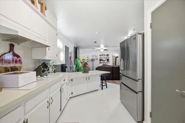 a kitchen with stainless steel appliances a refrigerator and a sink