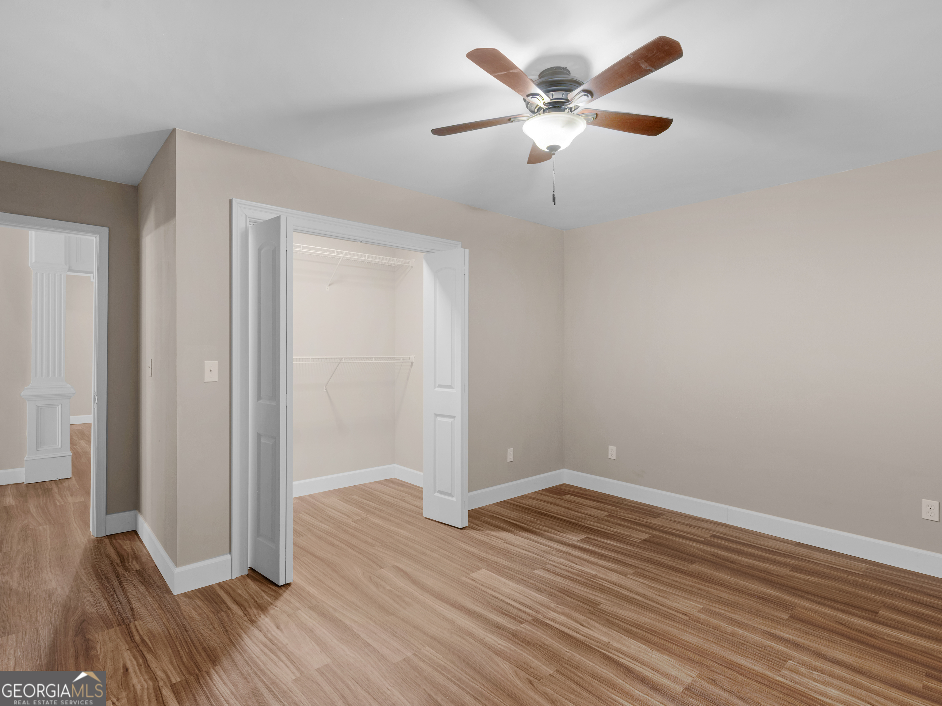 221 Hummingbird Court Hampton, GA 30228 - Photo 63 of 77 an empty room with wooden floor and ceiling fan