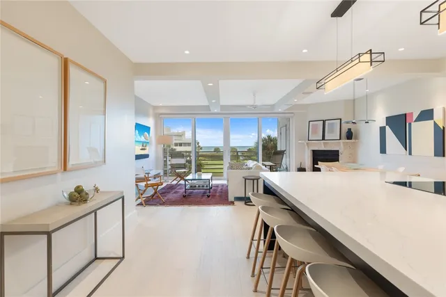 a very nice looking open dining room with kitchen island furniture and a wooden floor