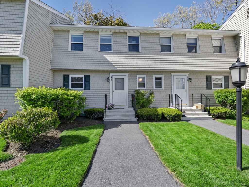 2255 Commonwealth Avenue, Unit 2255 Newton, MA 02466 - Photo 1 of 32 a front view of a house with a yard and potted plants