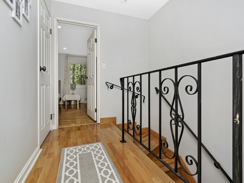 2255 Commonwealth Avenue, Unit 2255 Newton, MA 02466 - Photo 12 of 32 a view of a hallway with wooden floor and staircase