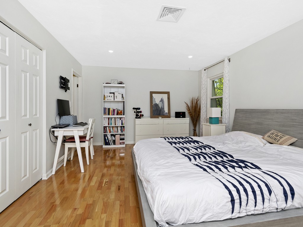 2255 Commonwealth Avenue, Unit 2255 Newton, MA 02466 - Photo 14 of 32 a bedroom with a bed and wooden floor