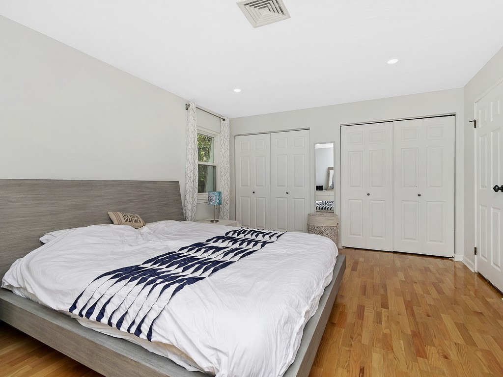 2255 Commonwealth Avenue, Unit 2255 Newton, MA 02466 - Photo 15 of 32 a bedroom with a bed and a wooden floor