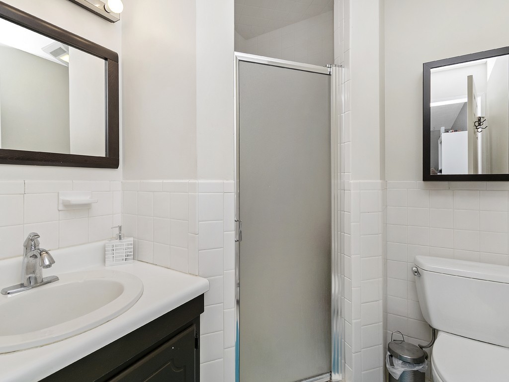 2255 Commonwealth Avenue, Unit 2255 Newton, MA 02466 - Photo 16 of 32 a bathroom with a toilet sink and mirror