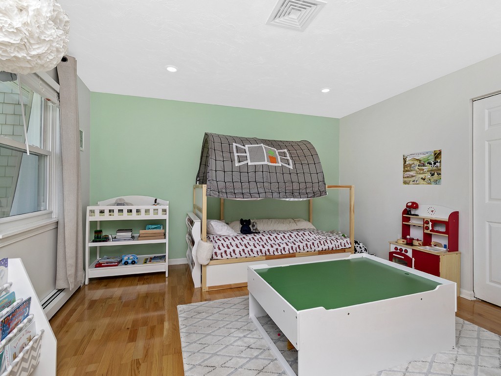 2255 Commonwealth Avenue, Unit 2255 Newton, MA 02466 - Photo 17 of 32 a living room with a bed and a couch
