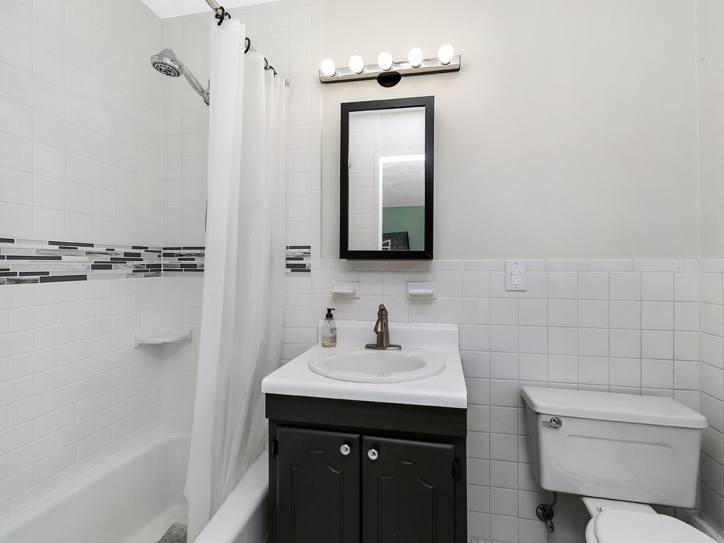 2255 Commonwealth Avenue, Unit 2255 Newton, MA 02466 - Photo 20 of 32 a bathroom with a sink toilet and shower