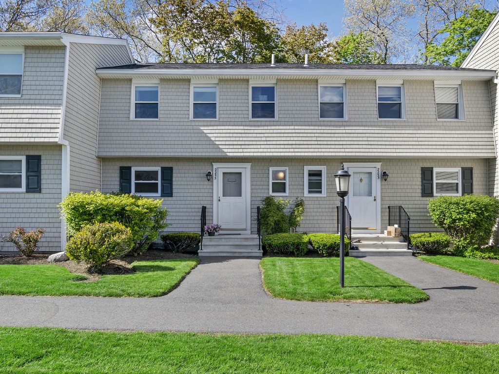 2255 Commonwealth Avenue, Unit 2255 Newton, MA 02466 - Photo 2 of 32 a front view of a house with a yard and potted plants