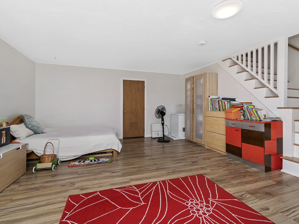 2255 Commonwealth Avenue, Unit 2255 Newton, MA 02466 - Photo 24 of 32 a room with stairs and a wooden floor