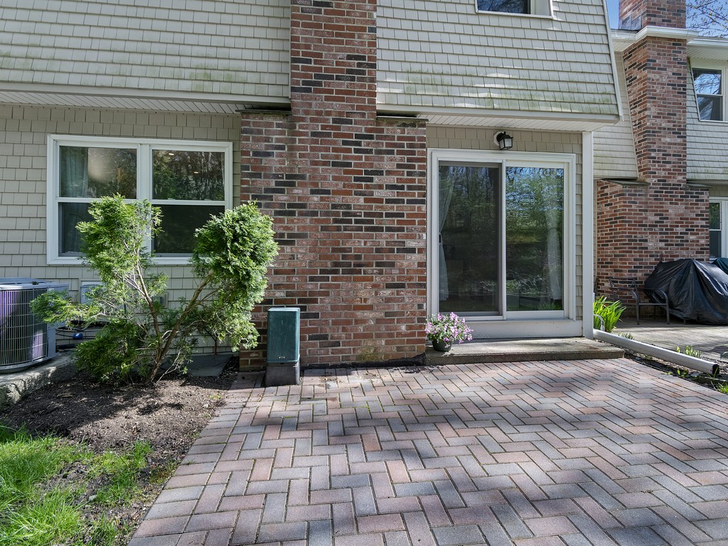2255 Commonwealth Avenue, Unit 2255 Newton, MA 02466 - Photo 28 of 32 a view of a brick house with a yard