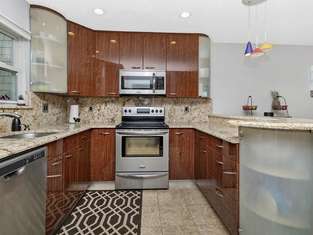 2255 Commonwealth Avenue, Unit 2255 Newton, MA 02466 - Photo 4 of 32 a kitchen with stainless steel appliances granite countertop a sink stove and cabinets