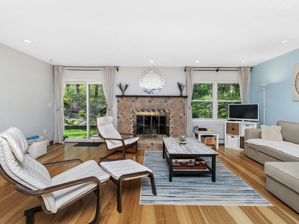 2255 Commonwealth Avenue, Unit 2255 Newton, MA 02466 - Photo 6 of 32 a living room with furniture fireplace and a large window