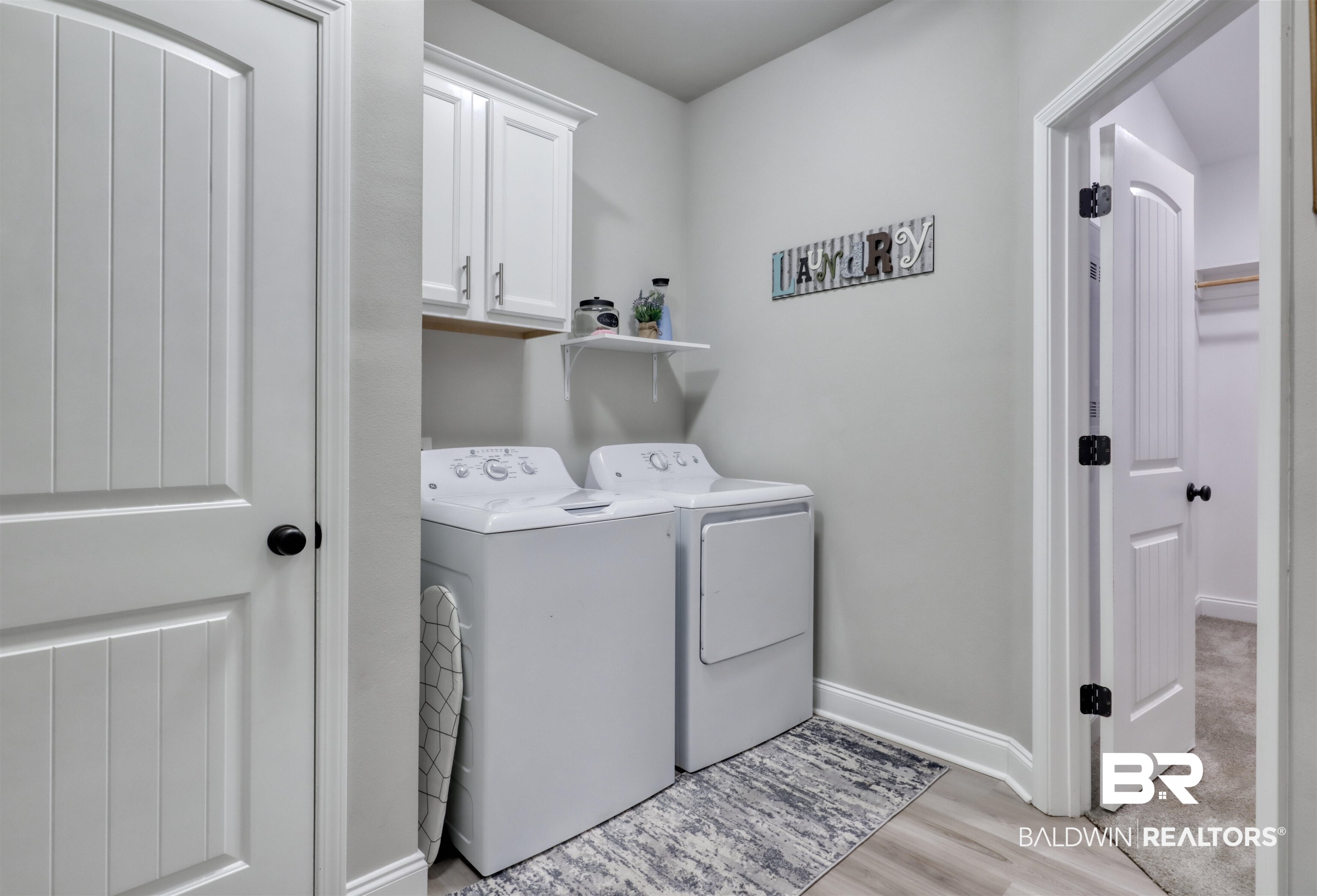 987 Gibson Court Foley, AL 36535 - Photo 27 of 34 Laundry area with light wood-type flooring, cabinet space, independent washer and dryer, and baseboards