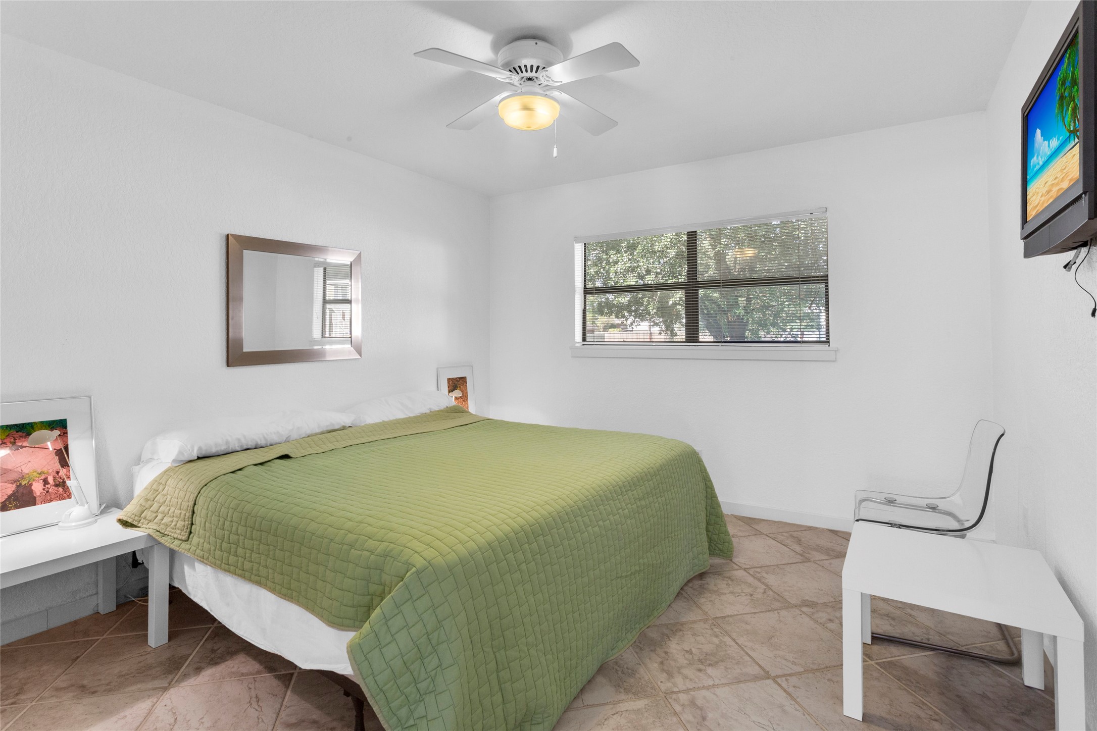 67 Harbor Lane Kemah, TX 77565 - Photo 31 of 47 This secondary bedroom is bright and minimalistic, featuring a large window that allows natural light to fill the space and provides a water view.