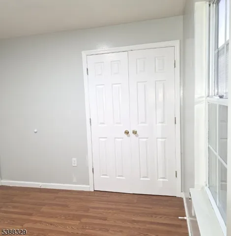 a view of hallway with wooden floor