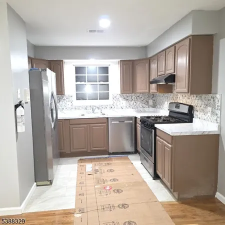 a kitchen with a sink stove and refrigerator