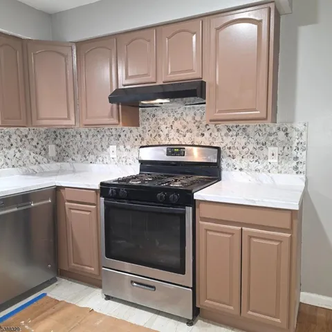 a kitchen with granite countertop cabinets stainless steel appliances and sink