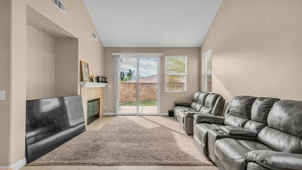 a living room with furniture and a dining table
