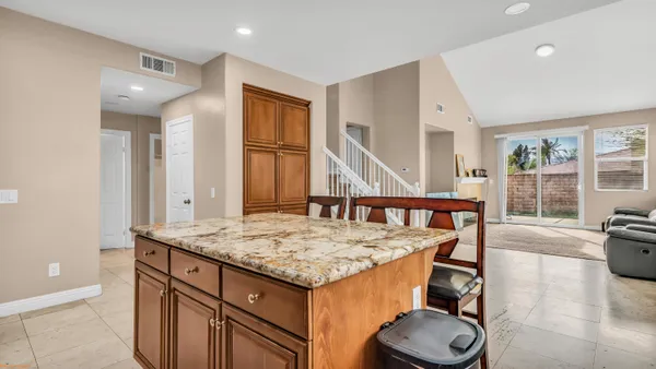 a bathroom with a granite countertop sink and mirror