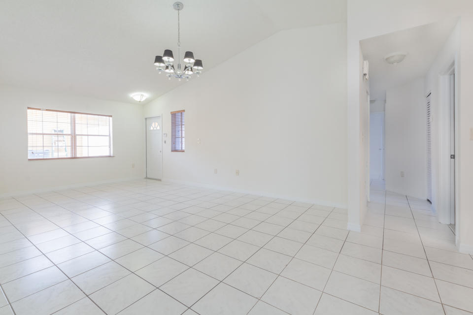 17841 Southwest 144th Avenue Miami, FL 33177 - Photo 5 of 19 an empty room with chandelier fan and window