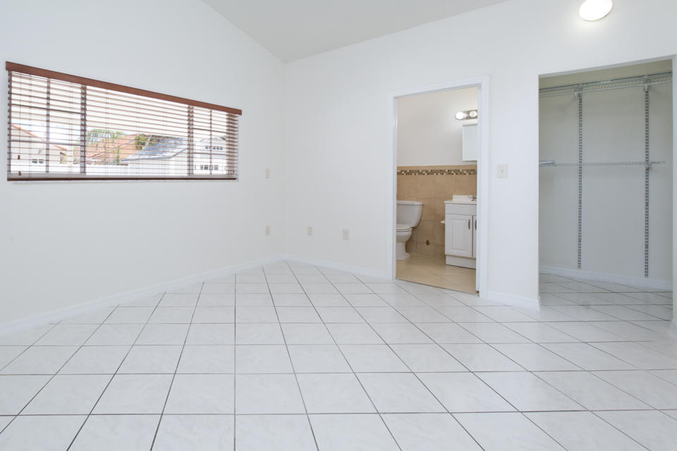 17841 Southwest 144th Avenue Miami, FL 33177 - Photo 10 of 19 en empty room with white walls and tiles