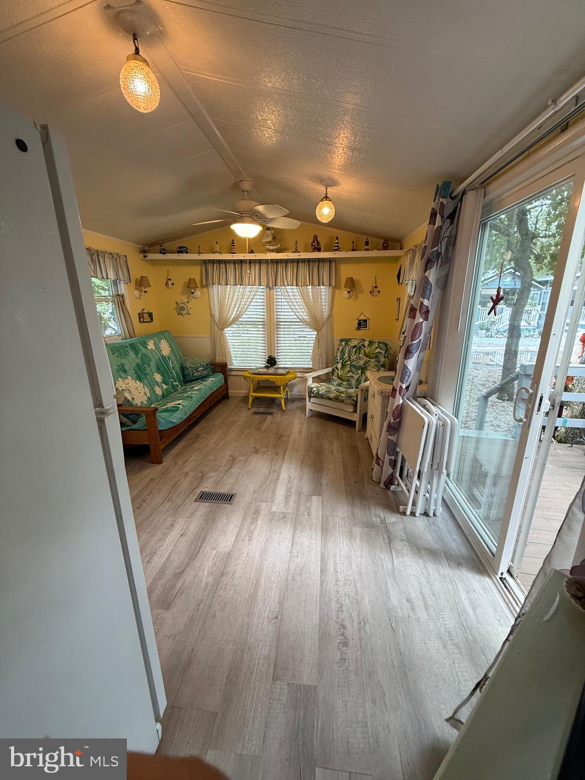 a view of a room with wooden floor