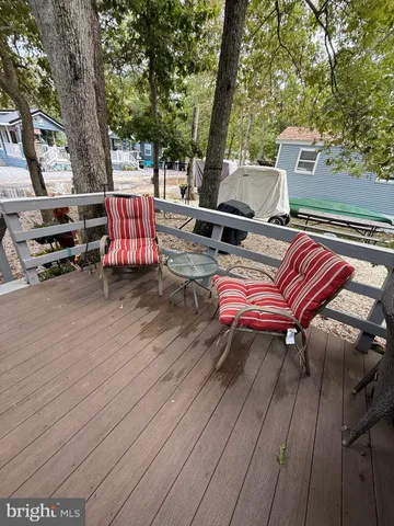an outdoor sitting area with couch and trees