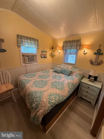 a bedroom with a bed and a night stand