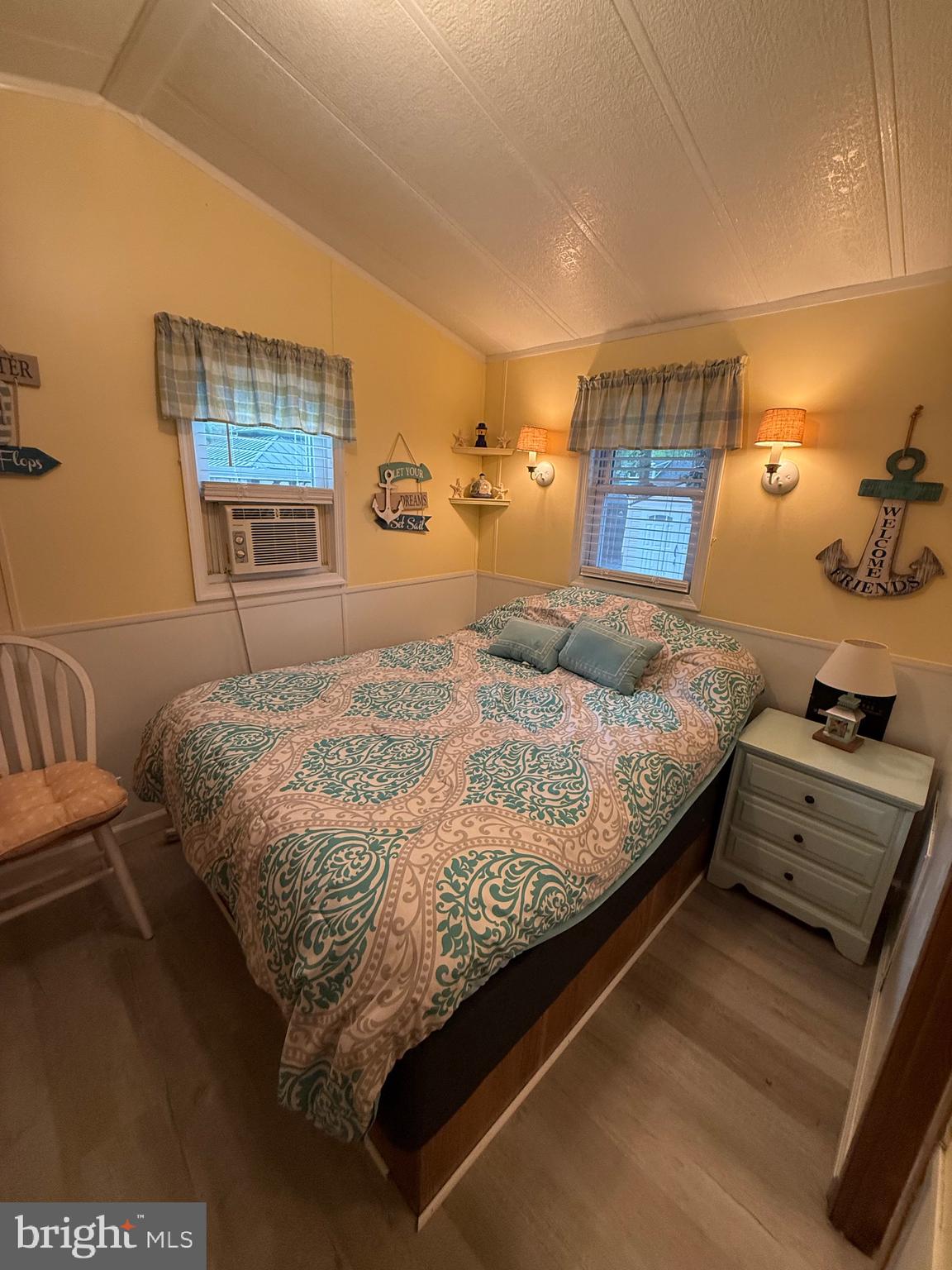 515 Corsons Tavern Road, Unit F49 Ocean View, NJ 08230 - Photo 10 of 12 a bedroom with a bed and a night stand