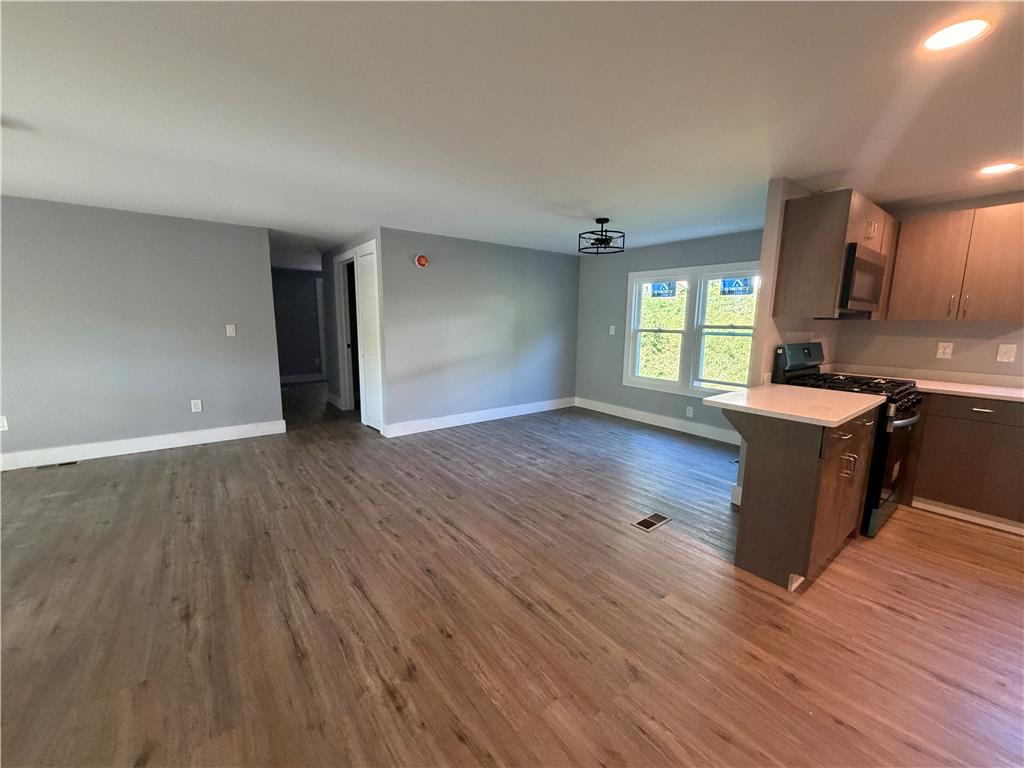 19 Springridge Road Bath, PA 18014 - Photo 12 of 29 An open layout connects the living spaces seamlessly over durable wood-look flooring.