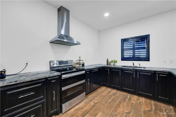 a kitchen with a sink and stove
