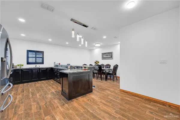 a living room with furniture a wooden floor and a sink