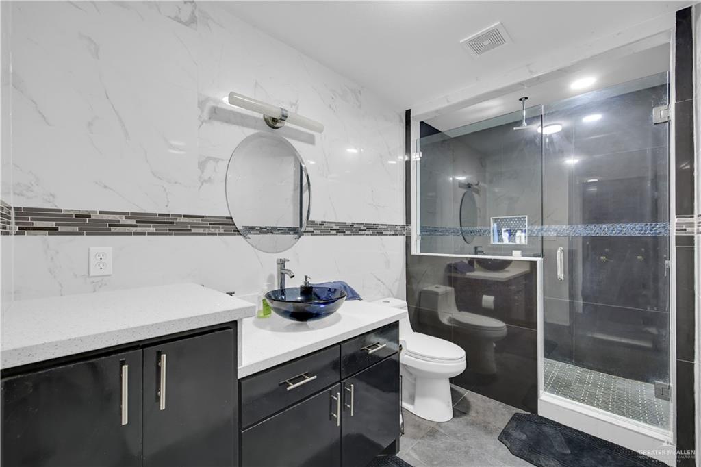 26072 Brushline Road Edcouch, TX 78538 - Photo 20 of 32 a bathroom with a sink a toilet and shower