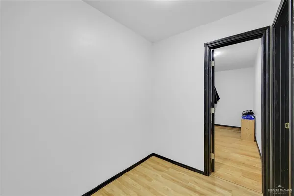 a view of a room with wooden floor and cabinet