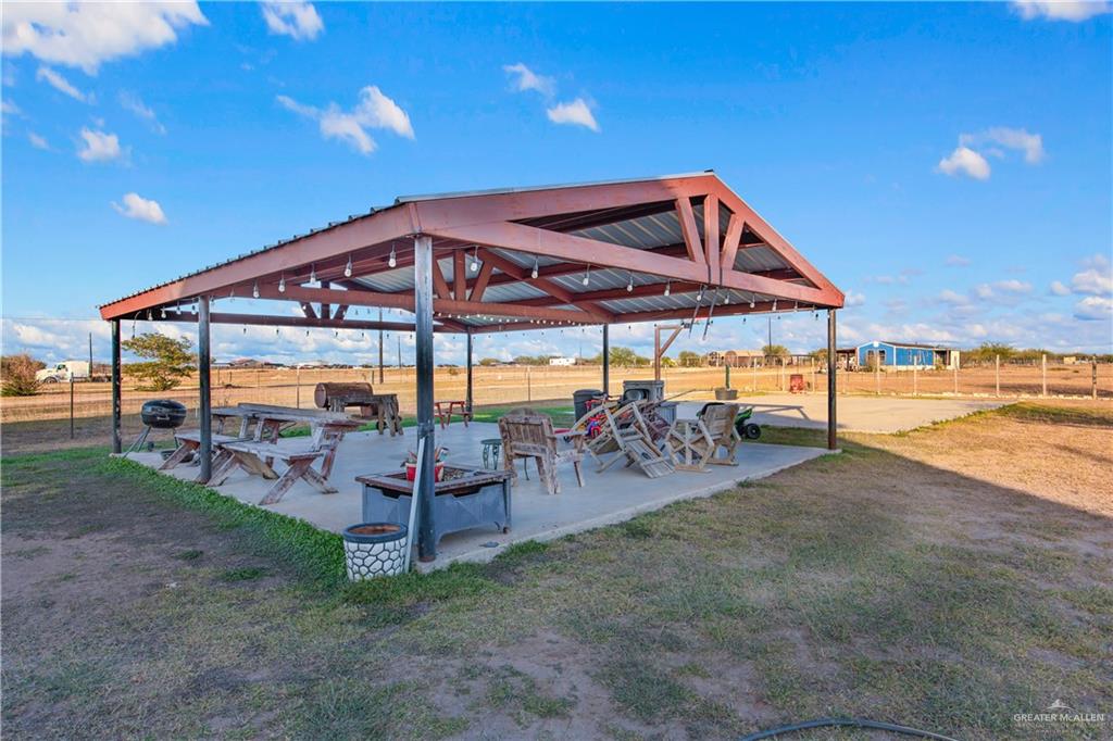 26072 Brushline Road Edcouch, TX 78538 - Photo 27 of 32 a view of a backyard with a patio and outdoor seating