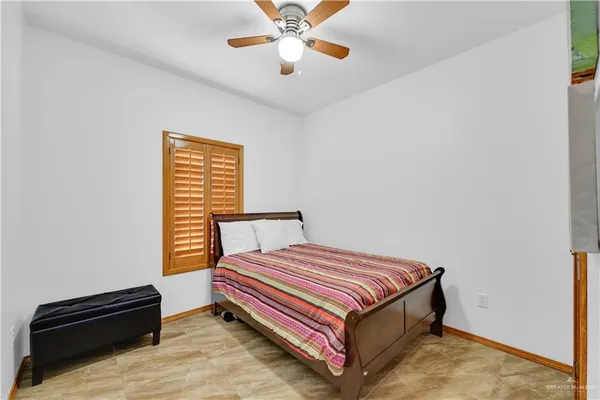 a bedroom with a bed and a ceiling fan