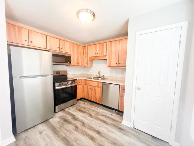 a kitchen with a refrigerator a sink and a stove
