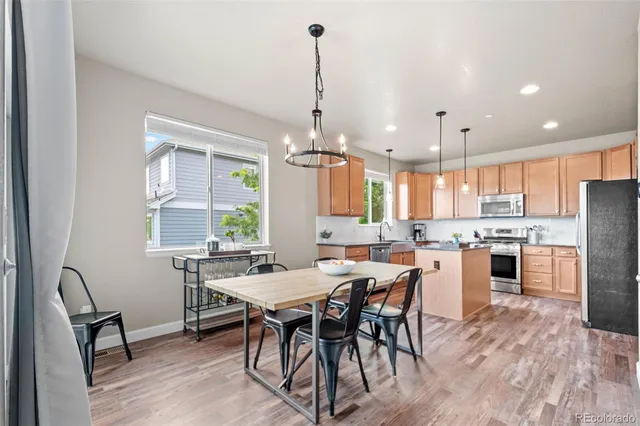 a kitchen with stainless steel appliances granite countertop a stove a sink a center island and cabinets