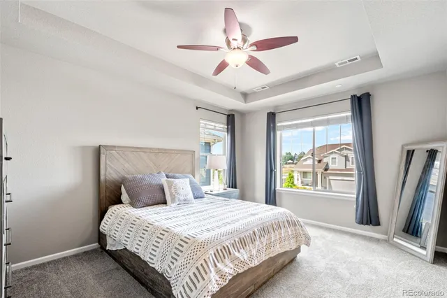 a bathroom with a granite countertop sink toilet and mirror