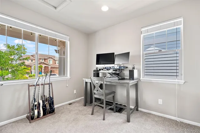 a living room with furniture a rug and a large window