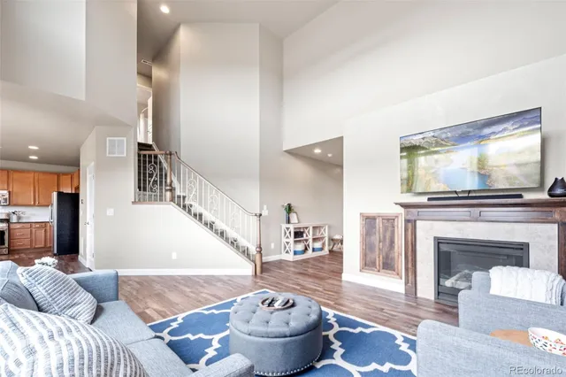 a kitchen with stainless steel appliances kitchen island granite countertop a table chairs and a refrigerator