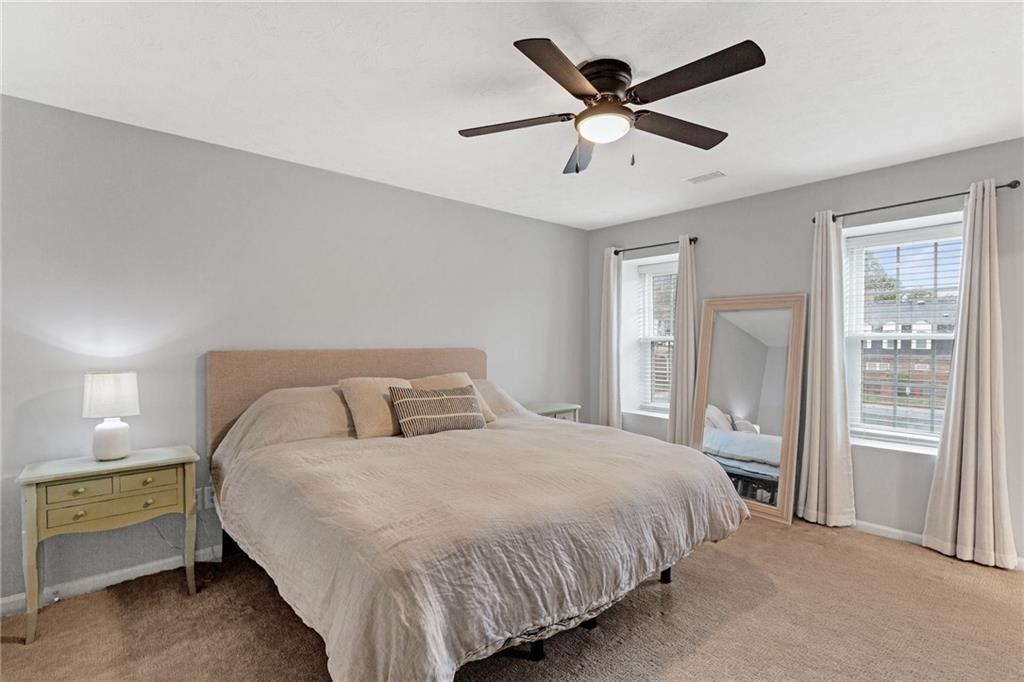 12 Surry County Place Northwest Atlanta, GA 30318 - Photo 13 of 27 a bedroom with a bed and a ceiling fan