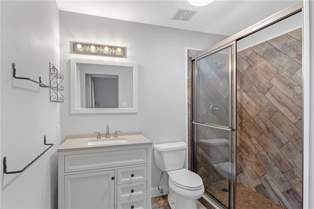 12 Surry County Place Northwest Atlanta, GA 30318 - Photo 15 of 27 a bathroom with a toilet a sink and shower