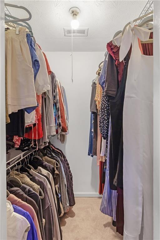 12 Surry County Place Northwest Atlanta, GA 30318 - Photo 16 of 27 a view of walk in closet with clothes and shoes