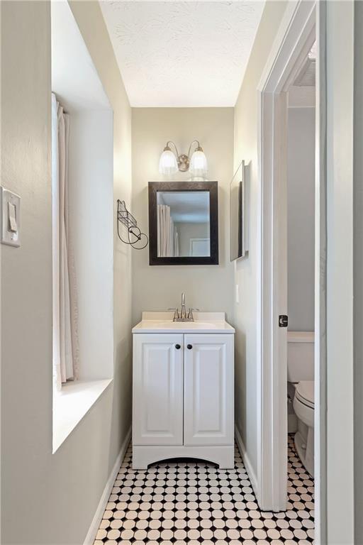 12 Surry County Place Northwest Atlanta, GA 30318 - Photo 19 of 27 a bathroom with a sink a mirror and a toilet