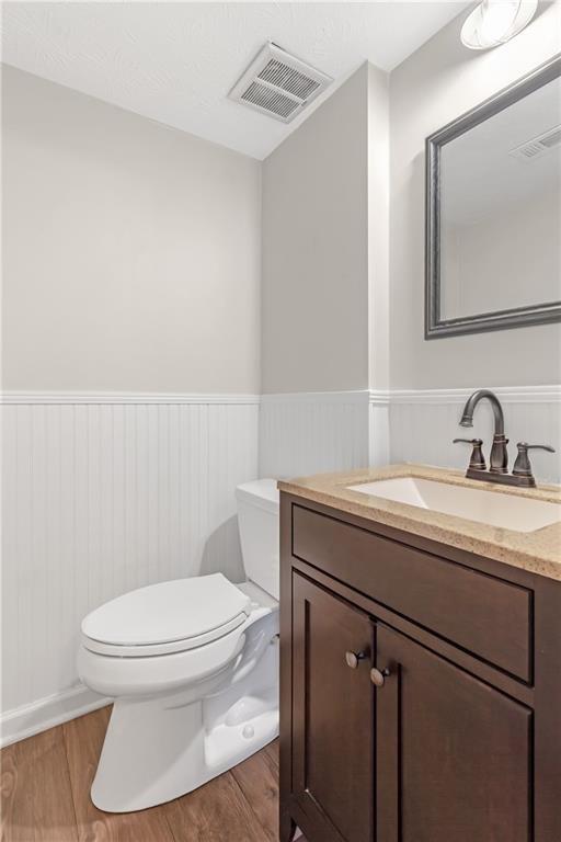 12 Surry County Place Northwest Atlanta, GA 30318 - Photo 5 of 27 a bathroom with a toilet a sink and mirror