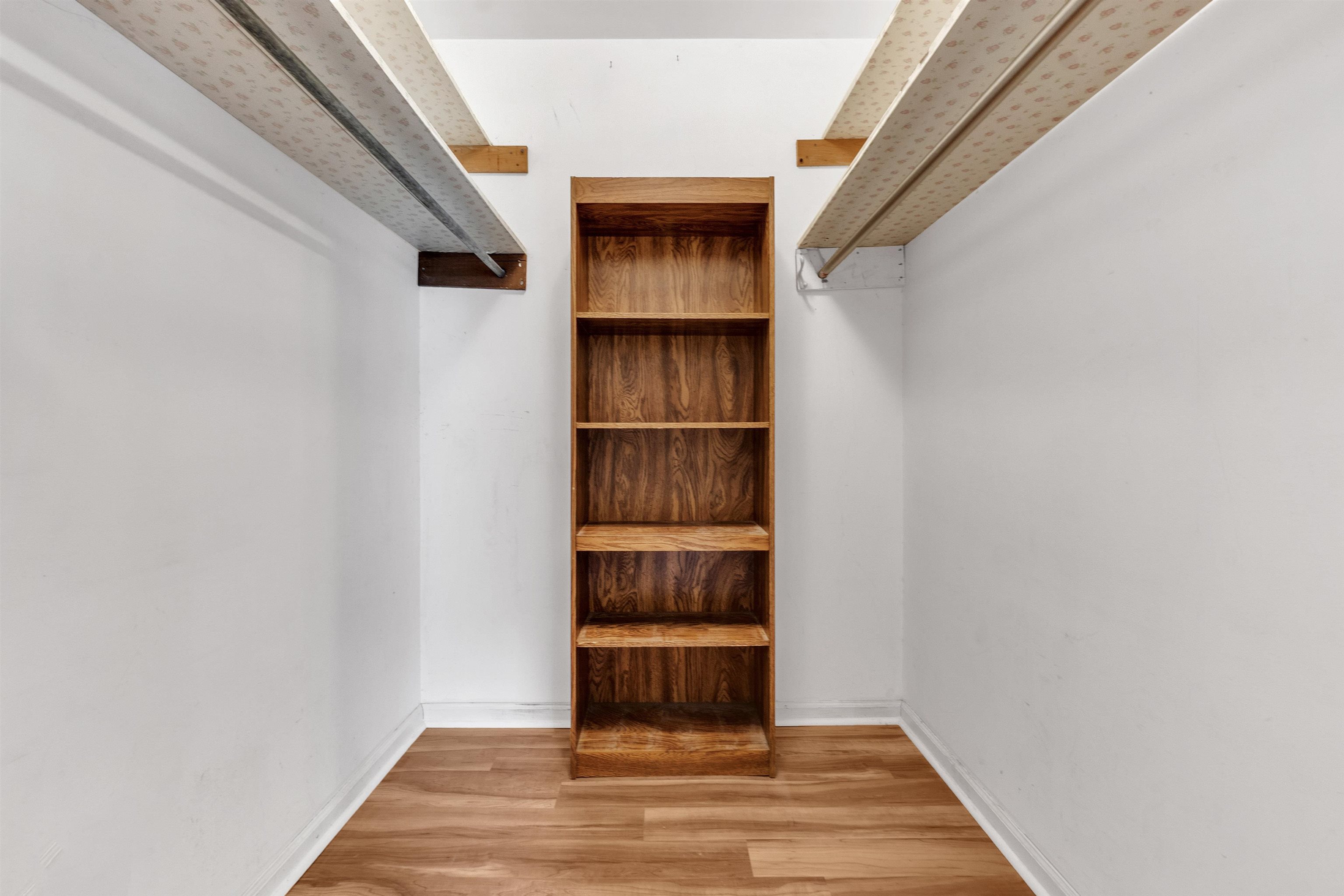 3024 Keats Road Bartlett, TN 38134 - Photo 22 of 32 Walk in closet with wood finished floors in primary bedroom