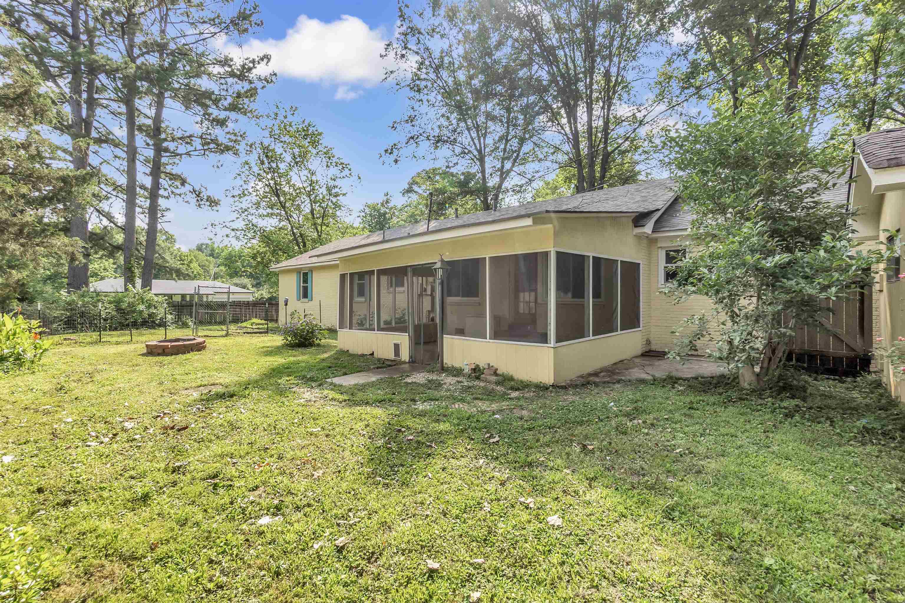 3024 Keats Road Bartlett, TN 38134 - Photo 29 of 32 Back of house with a sunroom, an outdoor fire pit, a fenced backyard, and roof with shingles