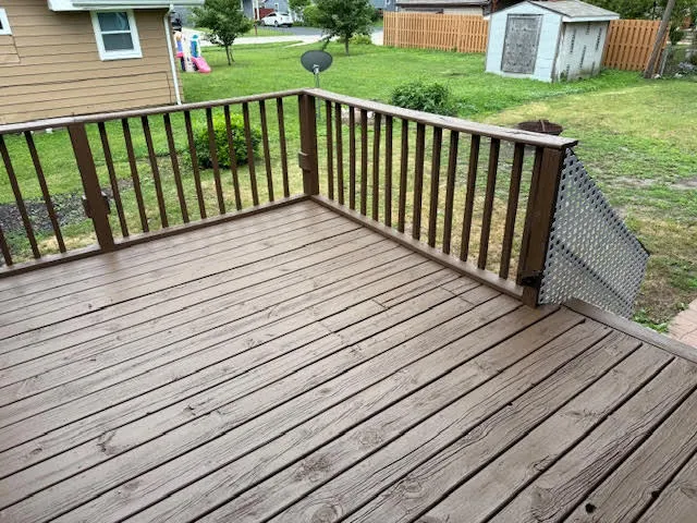 a view of a house with a yard and large tree