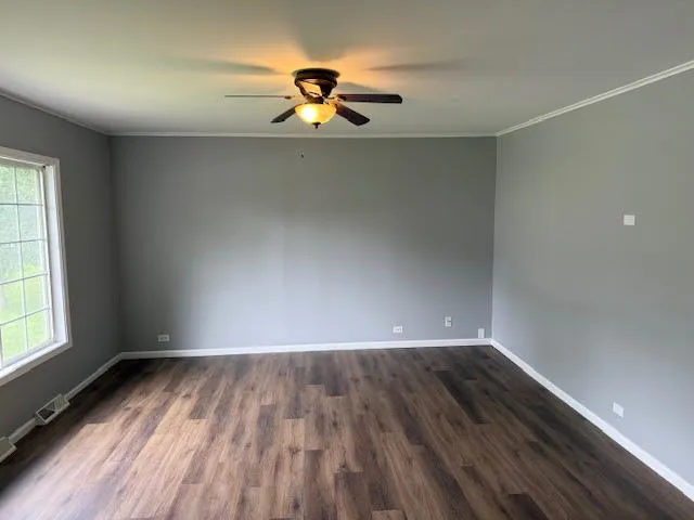 a view of a room with wooden floor and window