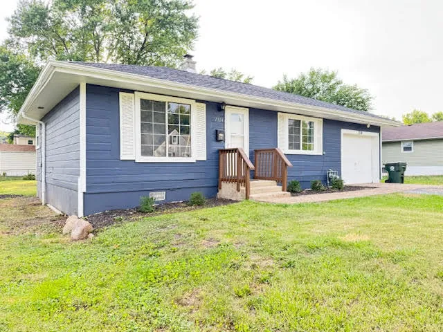 a backyard of a house with table and chairs